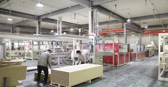WPC door production line in factory workshop